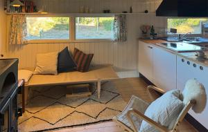 a small kitchen with a table and a couch at Tziki in Fanø