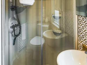 a bathroom with a shower with a toilet and a sink at Lodge 58 in Aviemore +6 photos