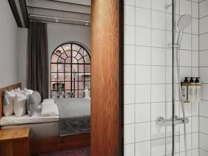 a bedroom with a bed and a glass shower at Ottilia Heritage in Copenhagen +64 photos