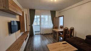 a living room with a couch and a table at Rădăuți Residence in Rădăuţi