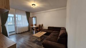 a living room with a couch and a table at Rădăuți Residence in Rădăuţi