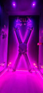a purple room with a sign that says jury just a jerk at VILLA CLOSE BRIVE centre - LOVE ROOM - SPA privatif in Brive-la-Gaillarde