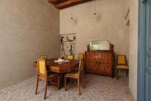 a dining room with a table and chairs and a mirror at Beit Felfel in Esna +31 photos