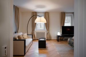 a living room with a couch and a flat screen tv at MEWS House Zürich in Zurich