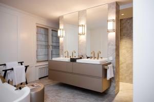 a bathroom with two sinks and a large mirror at MEWS House Zürich in Zurich