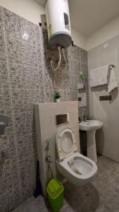 a bathroom with a toilet and a sink at Chill pad in Dehradun +16 photos