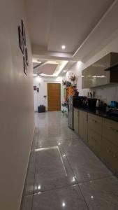 a large kitchen with a long hallway with a counter at Chill pad in Dehradun