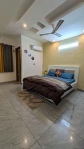 a bedroom with a bed with a ceiling fan at Chill pad in Dehradun