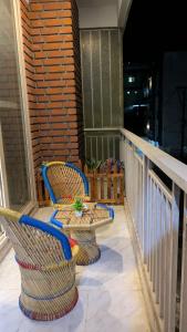 two chairs and a table on a balcony at Chill pad in Dehradun