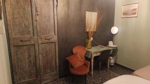 a room with a table and a chair and a lamp at Lavagna Uno in Genoa