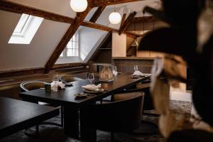 a dining room with tables and chairs and windows at MEWS House Zürich in Zurich