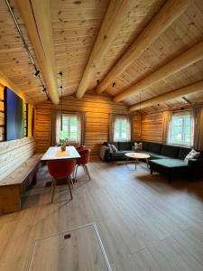 a large living room with wooden walls and wooden floors at Gunhild-stugu in Skogbygd