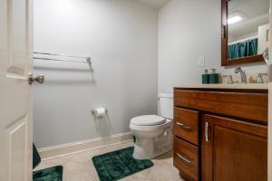 a bathroom with a toilet and a sink and a mirror at 5 Woods Dr in Mechanicsburg