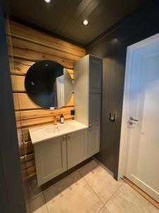 a bathroom with a sink and a mirror at Gunhild-stugu in Skogbygd +57 photos