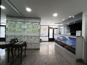 a room with a table and a wall with a map at Hostal Doña Isabel in Majadahonda