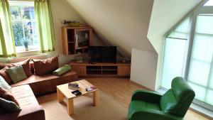 a living room with a couch and a table at Nixe in Timmendorf