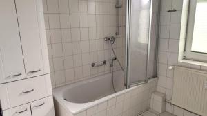 a bathroom with a shower and a bath tub at Nixe in Timmendorf +11 photos