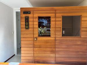 a wooden door with a window on it at Chalet De Drentse Rust in Erm