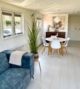 a living room with a couch and a table at Chalet De Drentse Rust in Erm +26 photos