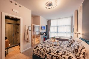 a bedroom with a bed and a room with a window at Boutique Casa Giulietta Luxury in Como