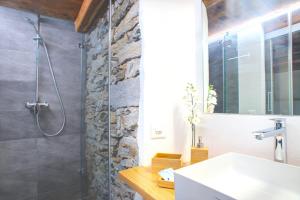 a bathroom with a shower and a sink at MyVerzasca Boutique Hotel in Brione