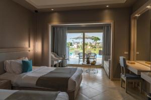 a hotel room with two beds and a patio at Sunrise Crystal Bay Resort -Grand Select in Hurghada +49 photos