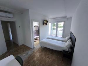 a white room with a bed and a window at Grace House in Padova