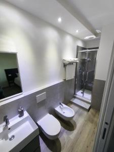 a bathroom with a toilet and a sink and a shower at Grace House in Padova