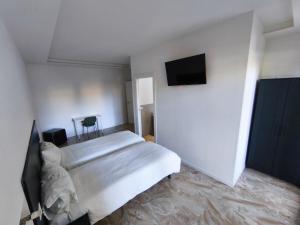a bedroom with a bed and a flat screen tv at Grace House in Padova +21 photos