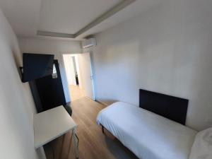 a bedroom with a bed and a table and a door at Grace House in Padova