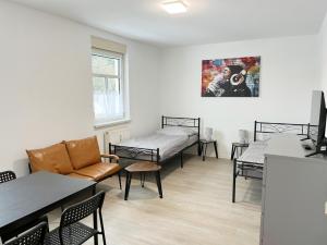 a waiting room with beds and a table and chairs at Monteurwohnung in Coswig in Coswig