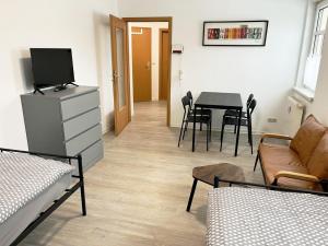 a living room with a tv and a table with chairs at Monteurwohnung in Coswig in Coswig