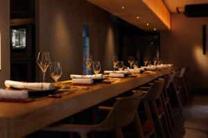 a long table in a restaurant with wine glasses at 奈良春日 鹿のや in Nara