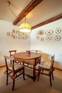 a dining room table with two chairs and plates on the wall at Chesa Cuntainta B 4pax - St Moritz in St. Moritz