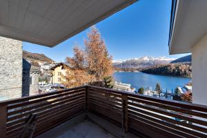 a balcony with a view of a lake at Chesa Cuntainta B 4pax - St Moritz in St. Moritz