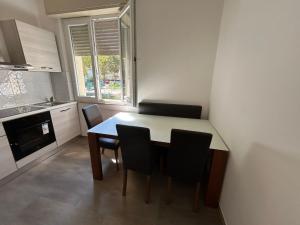 a kitchen with a table and chairs in a room at Hotel Bianca Vela in Rimini