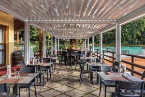 a restaurant with tables and chairs on a patio at Hotel Residence Campi in Tremosine Sul Garda