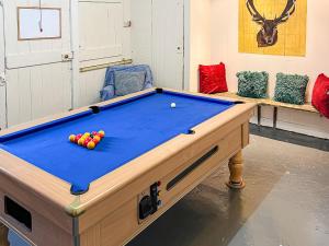 a pool table with balls on it in a room at Suisnish House in The Braes +17 photos