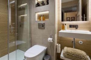 a bathroom with a shower and a toilet and a sink at Arran Shores Luxury Shorefront Apartment 2 in Lamlash
