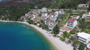 an aerial view of a beach with houses and boats at Apartments Rose in Stanići