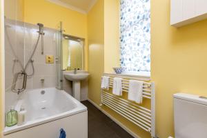 a bathroom with a tub and a sink at Appleton House - Lower Largo in Lower Largo +41 photos