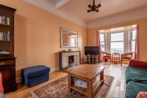 a living room with a couch and a fireplace at Appleton House - Lower Largo in Lower Largo