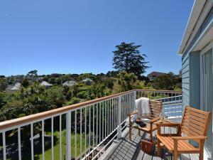 a balcony with two chairs and a view of the ocean at Florizel in Falmouth +2 photos