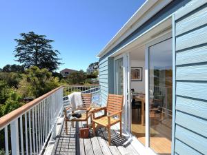 a balcony with two chairs and a table on it at Florizel in Falmouth