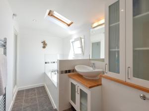 a white bathroom with a sink and a mirror at Florizel in Falmouth