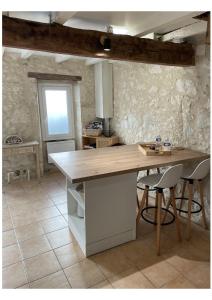 a kitchen with a wooden counter top in a room at La Pierre Pourpre in Eymet