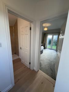 a hallway with a door leading to a bedroom at Silvermead stables Own access studios near Plymouth Life Centre FREE parking in Plymouth +21 photos