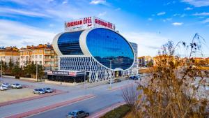 a large building on a city street with a road at GHERDAN GOLD OTEL in Konya