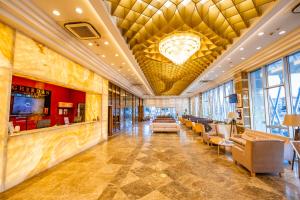a lobby of a hotel with couches and a chandelier at GHERDAN GOLD OTEL in Konya
