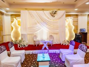 a room with a stage with chairs and a table at GHERDAN GOLD OTEL in Konya